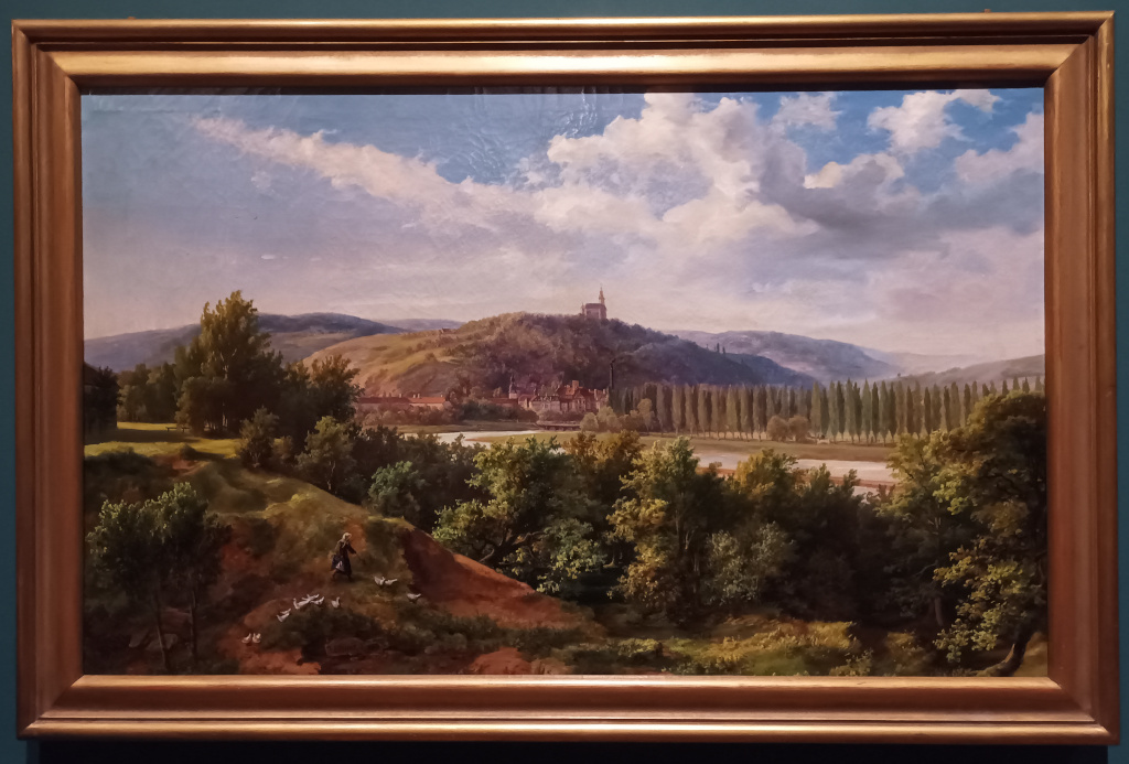 J. Elsner: Zbraslav od Komořan 1863. V popředí teče Vltava lemovaná topolovou alejí, zprava přitéká Berounka pod dřevěným mostem (dnes slepé rameno Krňák, protože soutok řek je o dvě kilometry níže), na vrchu Havlín stojí kostel svatého Havla a pod ním se rozkládá zbraslavský zámek.