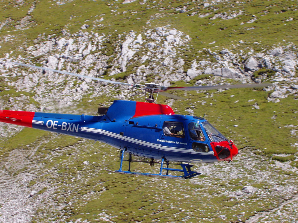 Lehký vrtulník přiváží lékaře na rendez vous s transportním záchranářským vrtulníkem v Tennengebirge.